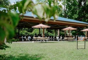 a group of tables and chairs with umbrellas at Bicentennial Inn in Buckhannon