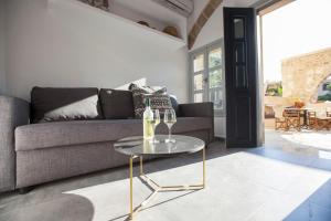 a living room with a couch and a glass table at The Old Town House in Rhodes Town