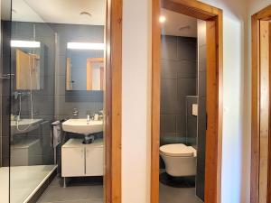 a bathroom with a sink and a toilet and a shower at Le Clavan - Studio à Crans-Montana (2-4 personnes) in Crans-Montana