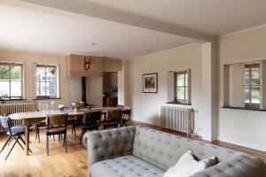 a living room with a couch and a table at Bosvilla Kennemerduinen in IJmuiden