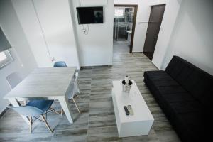 a living room with a table and a couch at Twins Apartments in Kato Pyrgos