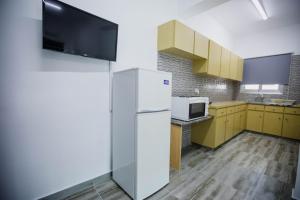 a kitchen with a refrigerator and a microwave at Twins Apartments in Kato Pyrgos