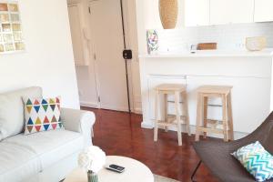 a living room with a couch and a table at Modern Cosy Flat with Terrace in Campo de Ourique. in Lisbon +17 photos