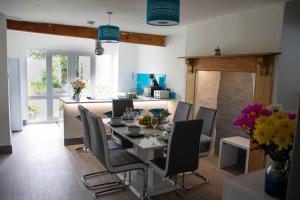 a dining room and kitchen with a table and chairs at Westeria Cottage in Barnstaple