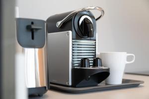 a coffee maker and a cup on a table at Apartaments Beach & Golf Resort in Pals