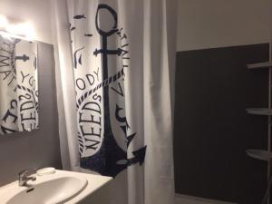 a bathroom with a sink and a shower curtain at Studio Les Lecques 100m de la plage in Saint-Cyr-sur-Mer