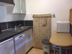 a small kitchen with a sink and a counter at Studio Les Lecques 100m de la plage in Saint-Cyr-sur-Mer