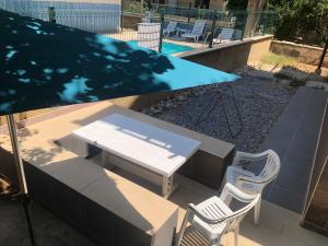 a picnic table and chairs next to a swimming pool at *** DiDiM BEYAZ *** in Didim
