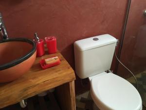 een badkamer met een wit toilet en een wastafel bij Coral in Punta Del Diablo