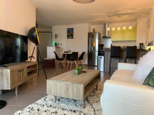 a living room with a white couch and a table at RAYAN 4 étoiles - Proche Lac & Vieille Ville, Garage Privé, Secteur recherché in Annecy