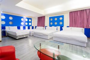 Postel nebo postele na pokoji v ubytování Newrise Hotel