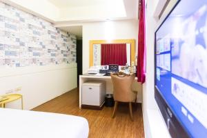 TV a/nebo společenská místnost v ubytování Newrise Hotel