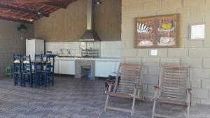 a kitchen with chairs and a table and a counter at Pousada Kabana de Pedra in Ibicoara