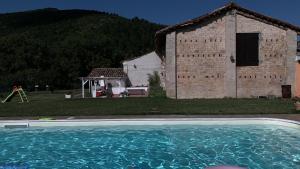 a large swimming pool in front of a building at Casa Vacanze Garofoli in Genga