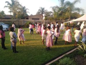 a group of people in white dresses on the grass at Sunrise Boutique Hotel in eMalahleni +79 photos