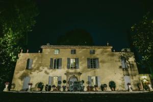 an old house with a car parked in front of it at Château de Saint-Girons - Luxury Guest House in Provence in Aix-en-Provence