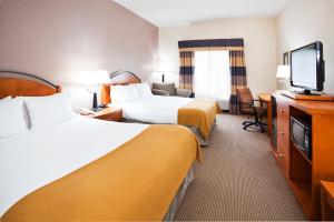 a hotel room with two beds and a flat screen tv at Holiday Inn Express Forest City, an IHG Hotel in Forest City