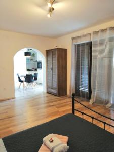 a bedroom with a bed and a dining room at Apartment Gabi in Umag