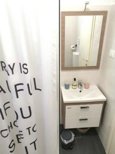 a bathroom with a white shower curtain and a sink at Apartment Gabi in Umag +16 photos