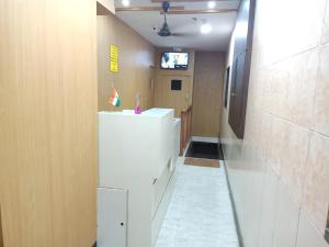 Cette chambre dispose d'un couloir avec un réfrigérateur blanc. dans l'établissement Mabrook Dormitory, à Mumbai