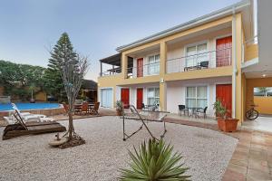 a house with a playground in front of it at Natalie Guesthouse in Bloubergstrand