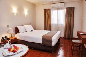 Postel nebo postele na pokoji v ubytování DM Hoteles Nasca