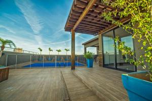 an outdoor deck of a house with a swimming pool at Hotel Leiria in Matão