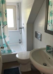 a bathroom with a sink and a toilet and a shower at Budapester Hof Gästehaus in Hamburg