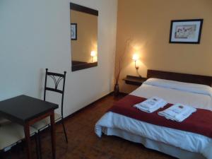 Ένα ή περισσότερα κρεβάτια σε δωμάτιο στο Hotel Minas