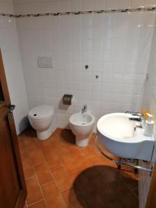 a bathroom with a toilet and a sink and a bidet at Panorama di Siena in Siena