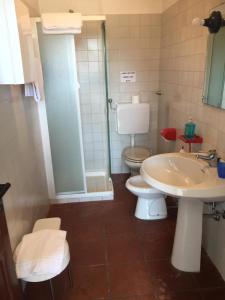 a bathroom with a toilet and a sink and a shower at Agriturismo Cargandino in Mezzomerico