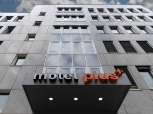 a building with a motel plus sign in front of it at Motel Plus Berlin in Berlin
