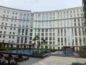 a large building with a pool in front of it at Eighty One Newport Boulevard in Manila