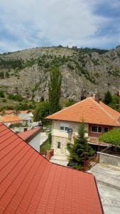 a roof of a house with a mountain in the background at Apartman AS in Livno