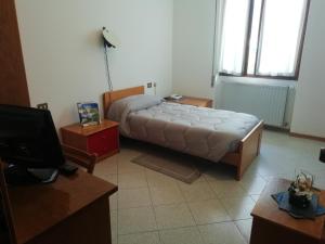 Säng eller sängar i ett rum på Hotel Rezia Valtellina