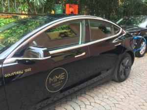a black car parked on a brick road at MaisonMe Boutique Hotel in Bardolino