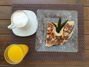 a table with a plate of food and a cup of coffee at Pacha Tulum Boutique Hotel in Tulum