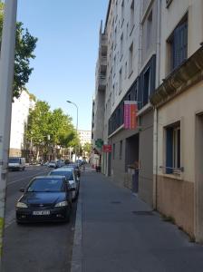 a black car parked on the side of a street at Appartements Le Berliet - Montplaisir in Lyon