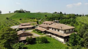 an aerial view of a house in a green field at Agriturismo Il Tondino in Tabiano