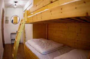 a bedroom with two bunk beds with a ladder at L'Orée des Bois - Studio avec terrasse au calme in Les Orres