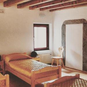 Tempat tidur dalam kamar di Ostello Sociale Borgo Venno