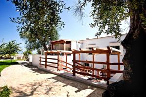 a house with a wooden fence next to a tree at Felicity Vieste in Vieste
