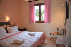 Postel nebo postele na pokoji v ubytování Melidron Hotel