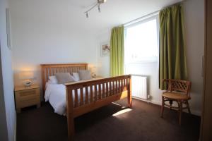 
a bedroom with a bed and a dresser at Seafield House in Brighton & Hove
