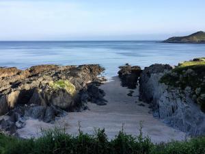 a view of the ocean from a rocky beach at Watersmeet Hotel in Woolacombe