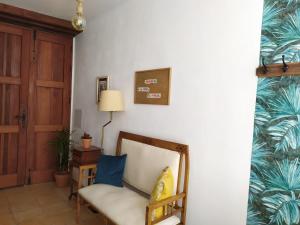 a living room with a chair and a lamp at La Casita de Ainhoa in Agüimes