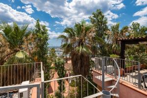 a view from the balcony of a house with palm trees at Pearl Coast Apartment in Santa Luria