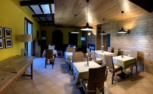 a restaurant with tables and chairs in a room at Ca Don Rafel in Castanesa