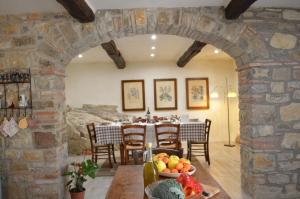 a stone archway in a dining room with a table at Agriturismo Podere Terrena in San Vincenti