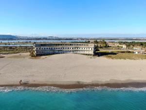 a building on the beach next to a beach at La Casa di Adele Cagliari B&B in Cagliari